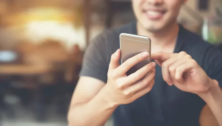 Man smiling at his phone